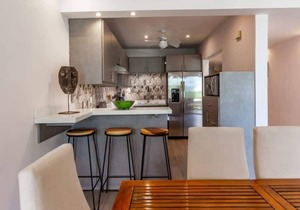 Elegant Condo with Brand-New Fixtures, Shaded Tropical Terrace, and Secluded Bea