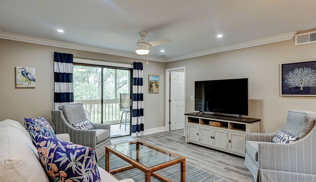 Fully updated condo with serene view, enclosed balcony, WiFi, W/D, pool, & gym